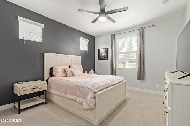 bedroom featuring ceiling fan, baseboards, and light colored carpet