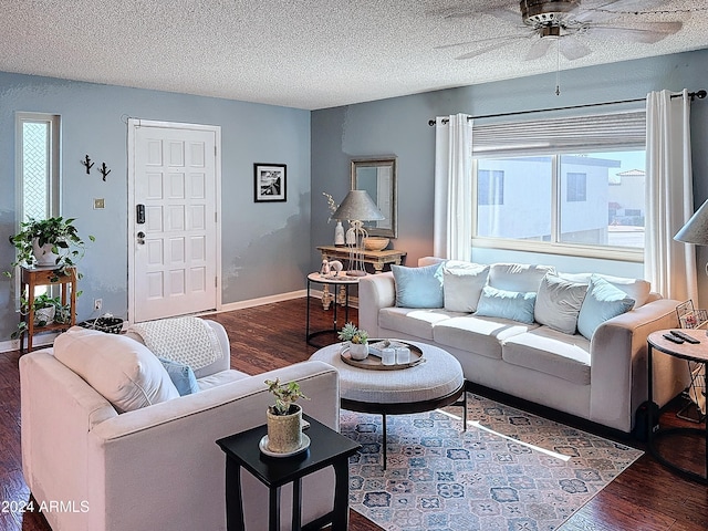 living room featuring ceiling fan, dark hardwood / wood-style flooring, and a textured ceiling