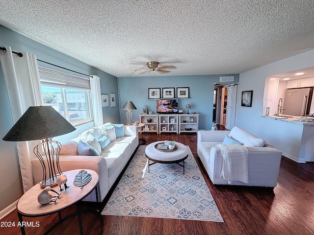 living room with sink, dark hardwood / wood-style floors, a textured ceiling, and ceiling fan