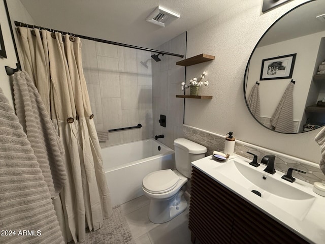 full bathroom featuring tile patterned floors, toilet, shower / bath combo with shower curtain, and vanity