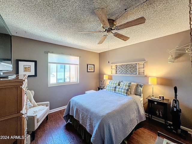 bedroom with dark wood-type flooring, ceiling fan, and a textured ceiling