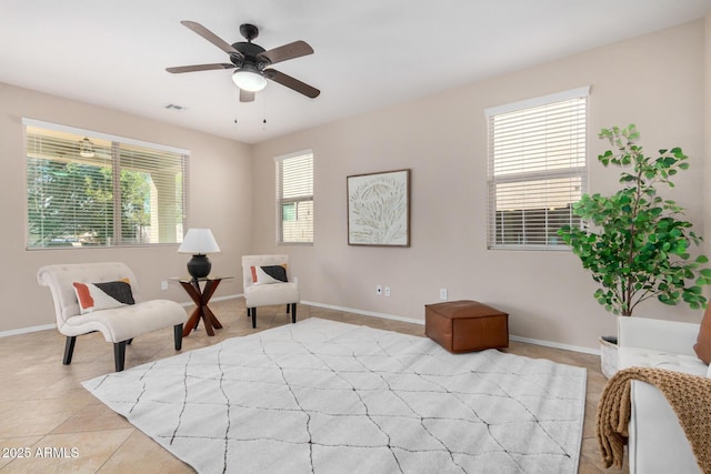 living area featuring visible vents, ceiling fan, baseboards, and light tile patterned floors