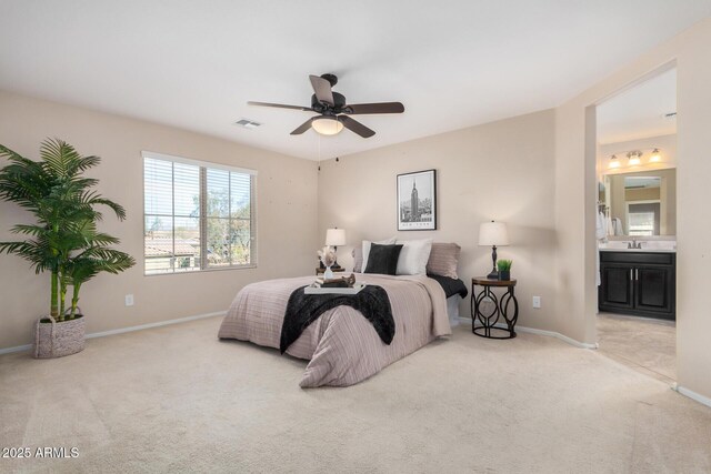 bedroom with baseboards, visible vents, a ceiling fan, light colored carpet, and ensuite bath