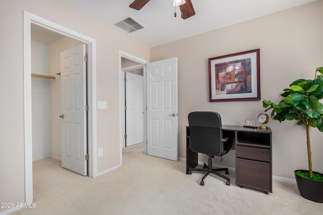 office space with a ceiling fan, light colored carpet, visible vents, and baseboards