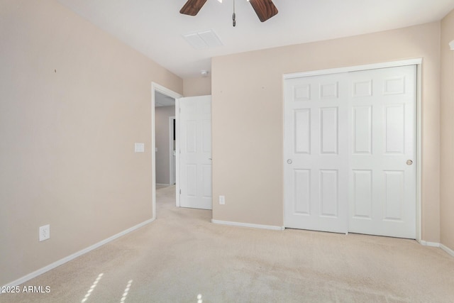 unfurnished bedroom with light colored carpet, a ceiling fan, baseboards, visible vents, and a closet