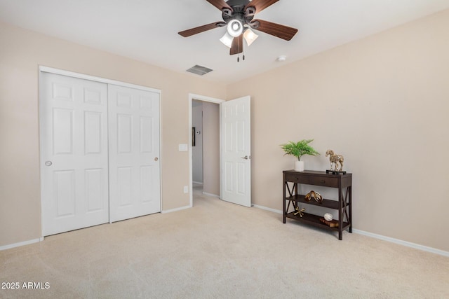 bedroom with light carpet, baseboards, visible vents, a ceiling fan, and a closet