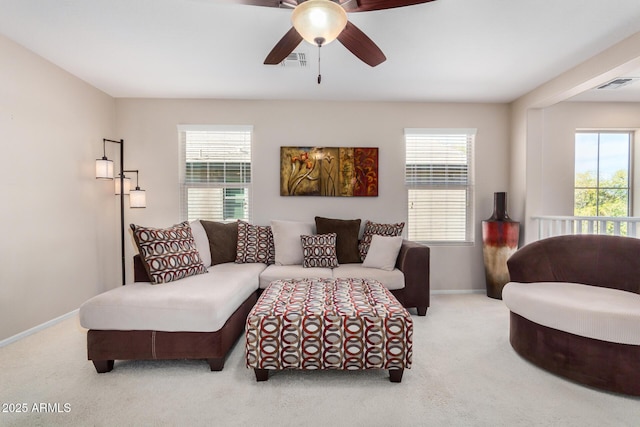 living room with light carpet, visible vents, and baseboards