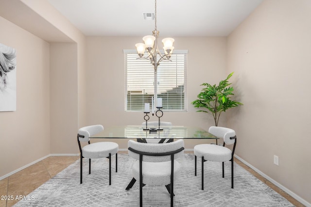 dining room with light tile patterned floors, visible vents, baseboards, and an inviting chandelier