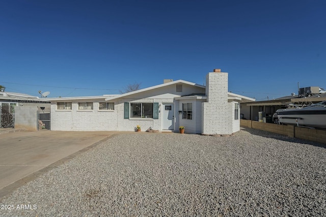 ranch-style home with a chimney