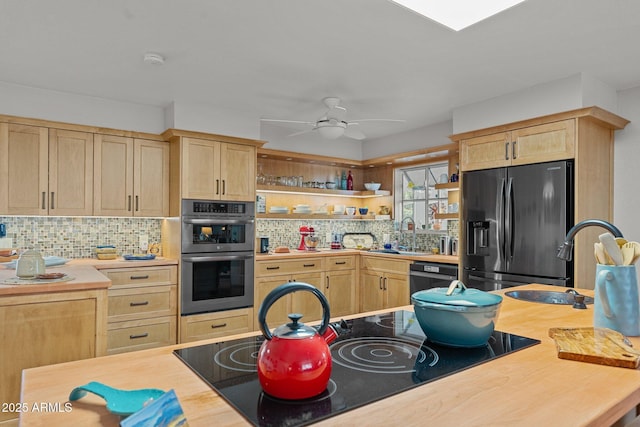 kitchen featuring backsplash, sink, light brown cabinets, and black appliances