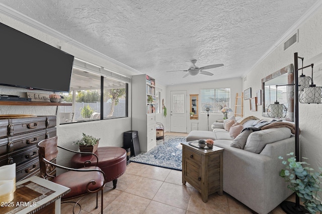 living room with light tile patterned floors, ornamental molding, a textured ceiling, and ceiling fan