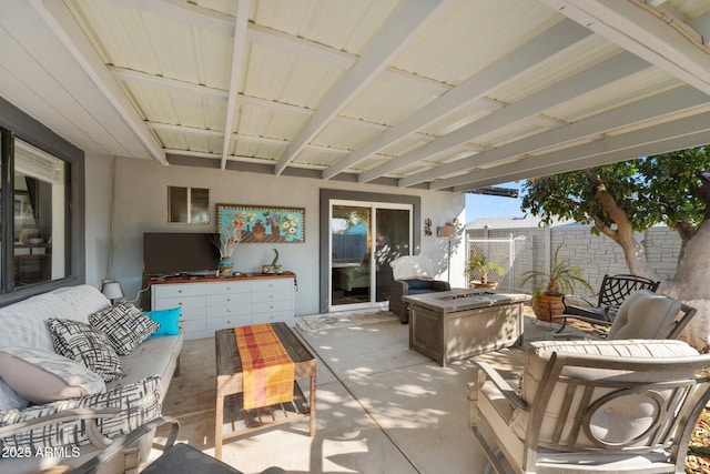 view of patio featuring an outdoor living space with a fire pit