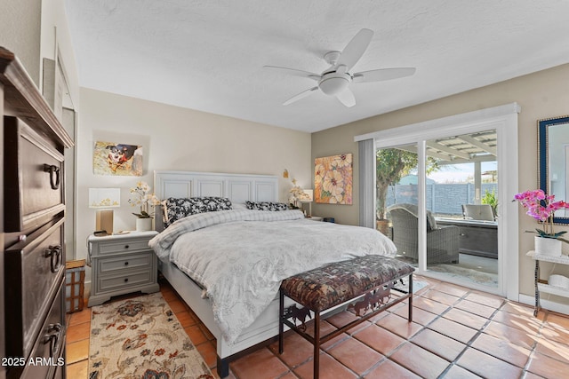 tiled bedroom featuring access to exterior, a textured ceiling, and ceiling fan