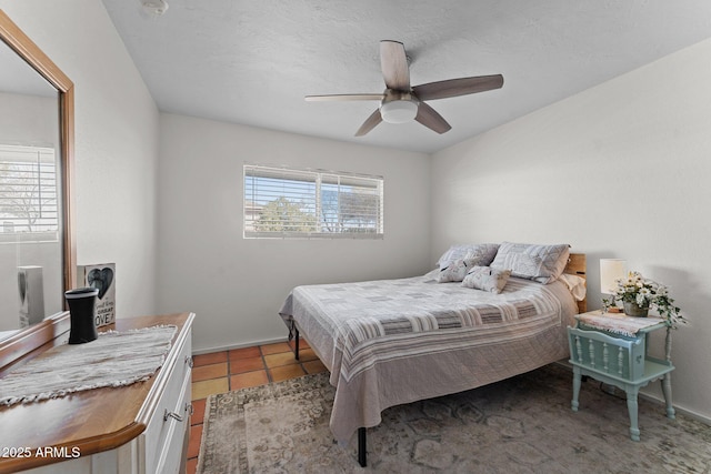 tiled bedroom featuring ceiling fan