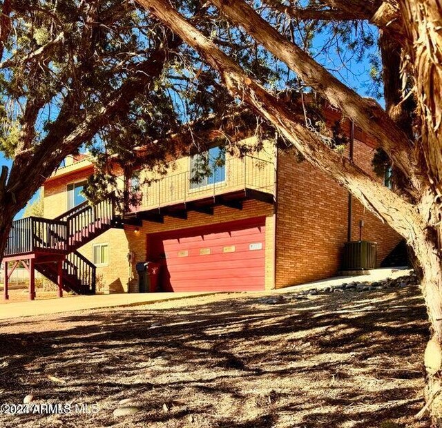 view of front of property featuring a garage and a front lawn