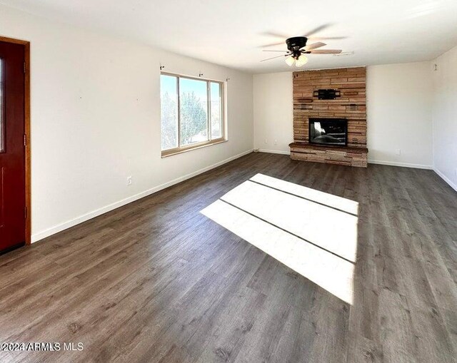 interior space with hardwood / wood-style floors, an AC wall unit, and ceiling fan