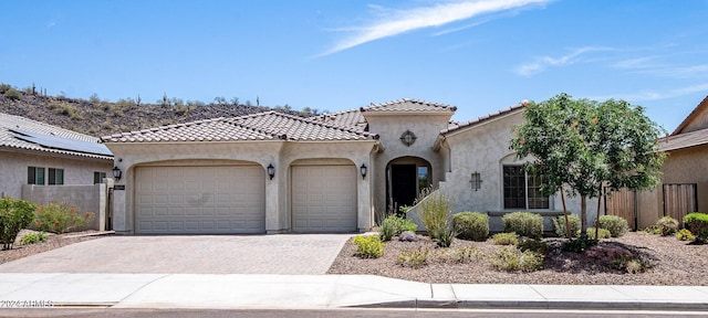 mediterranean / spanish house with a garage