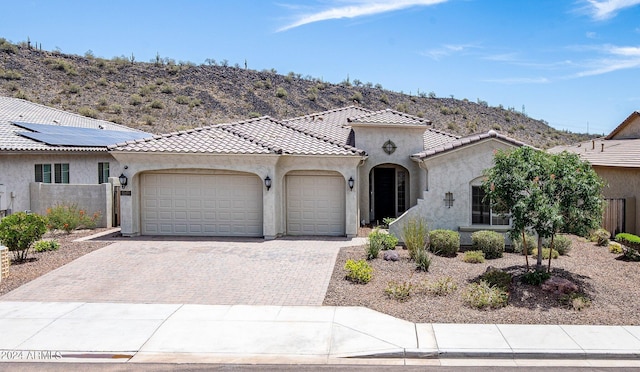 mediterranean / spanish-style house featuring a mountain view and a garage