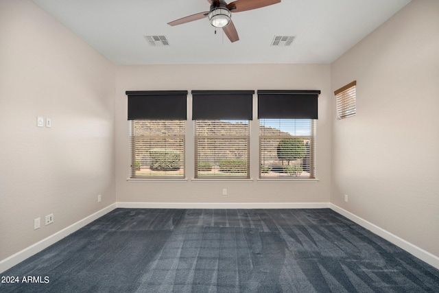 carpeted spare room featuring ceiling fan and a healthy amount of sunlight