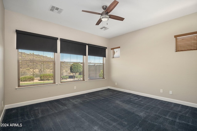 carpeted spare room featuring ceiling fan