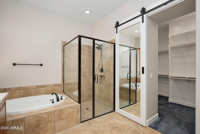 bathroom with vanity and shower with separate bathtub