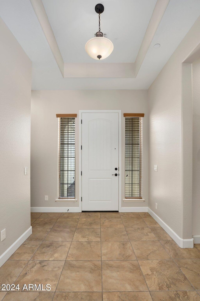 entrance foyer featuring a raised ceiling