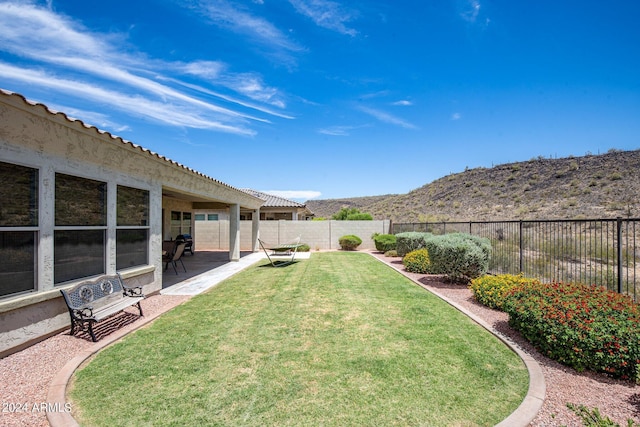 view of yard featuring a mountain view and a patio area