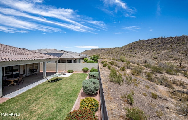 view of yard with a patio and a mountain view