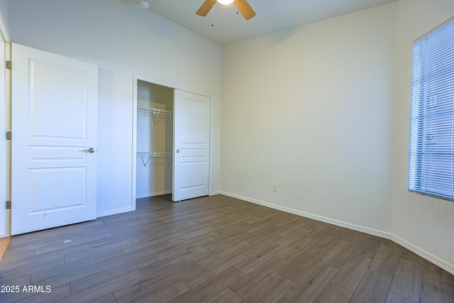 unfurnished bedroom featuring a closet, ceiling fan, and dark wood-type flooring