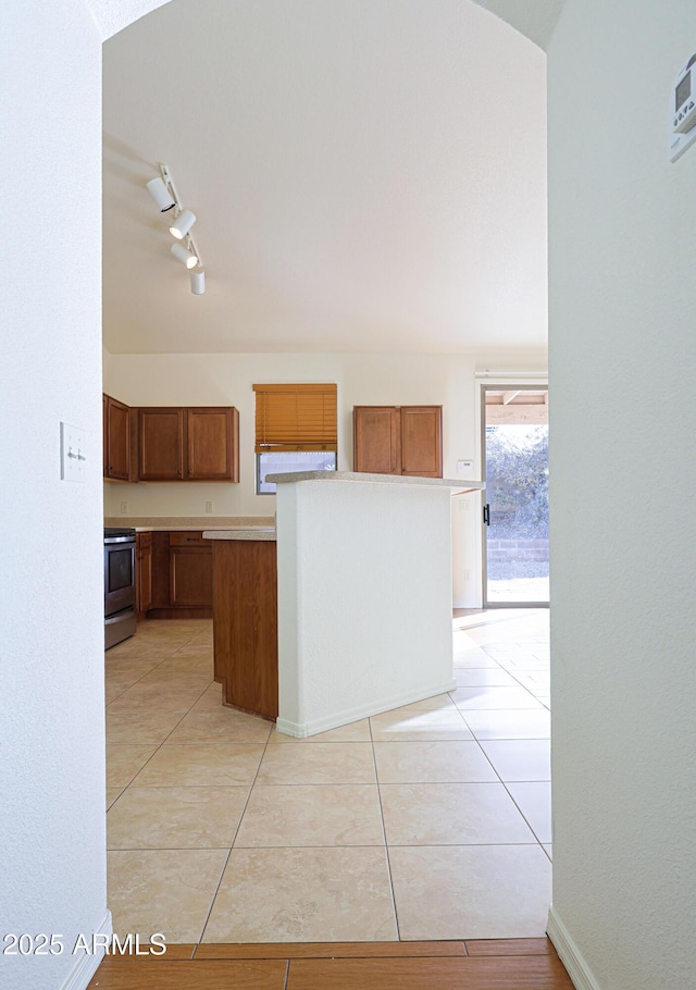 kitchen with stainless steel range and light tile patterned floors