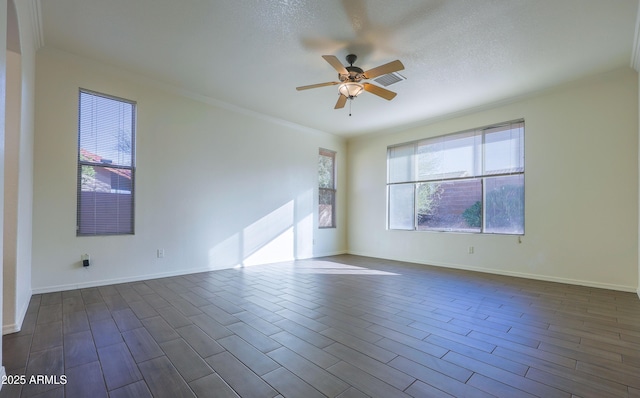 spare room with a textured ceiling, ceiling fan, and crown molding