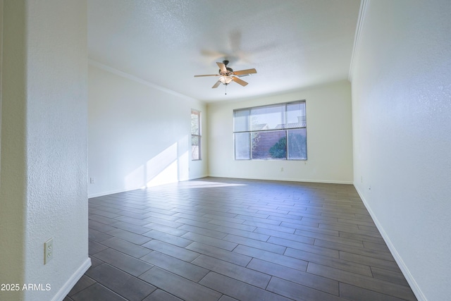 empty room with crown molding and ceiling fan