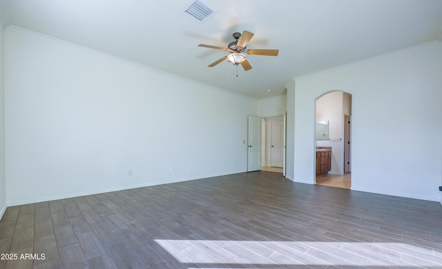 empty room with ceiling fan, dark hardwood / wood-style flooring, and ornamental molding