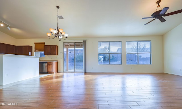 interior space with lofted ceiling, ceiling fan with notable chandelier, and light wood-type flooring