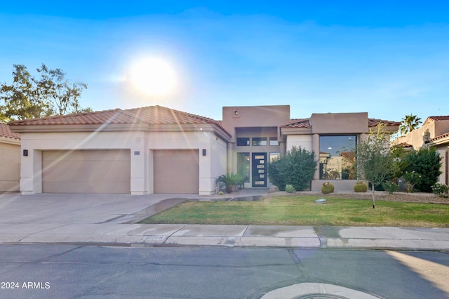 view of front of house with a front yard and a garage