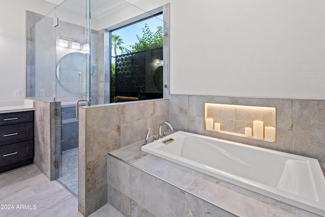 bathroom featuring vanity, ornamental molding, shower with separate bathtub, and tile walls