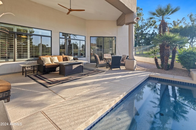 view of swimming pool featuring outdoor lounge area, a patio, and ceiling fan