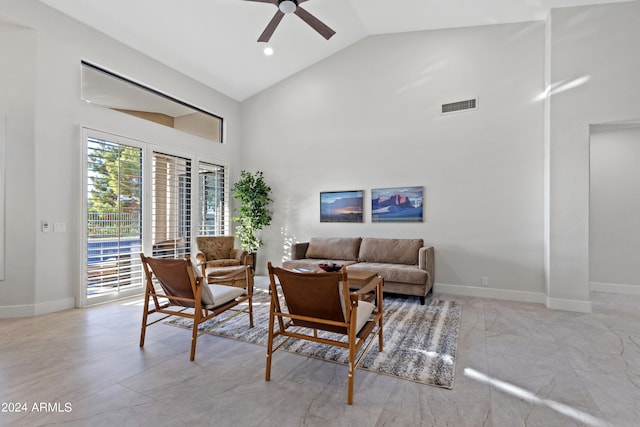 living room with ceiling fan and high vaulted ceiling