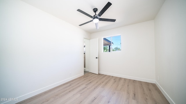 spare room with light hardwood / wood-style floors and ceiling fan