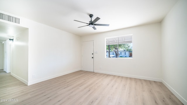 empty room with ceiling fan and light hardwood / wood-style flooring