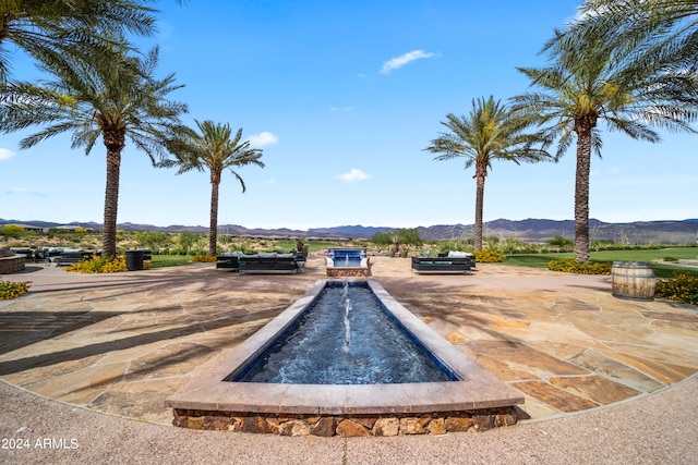 view of pool with a mountain view and a patio area