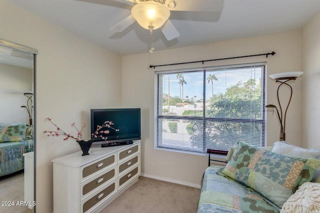 carpeted living room with ceiling fan