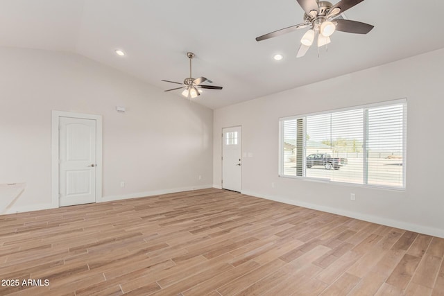 interior space with ceiling fan, vaulted ceiling, and light hardwood / wood-style flooring