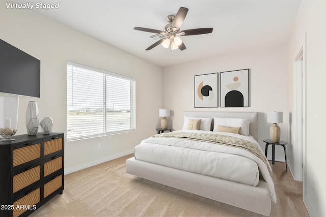 bedroom with light carpet and ceiling fan