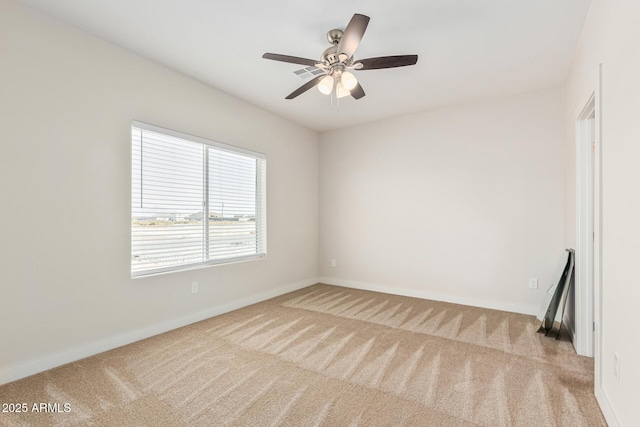 unfurnished room featuring light carpet and ceiling fan