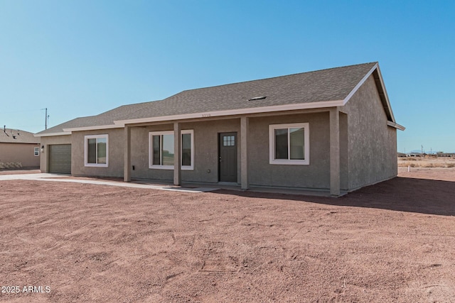 rear view of house featuring a garage