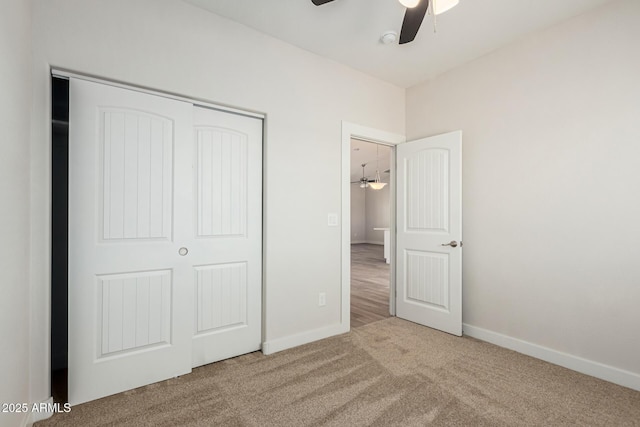 unfurnished bedroom featuring ceiling fan, a closet, and carpet flooring