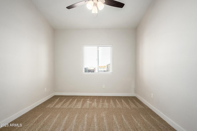 carpeted spare room featuring ceiling fan