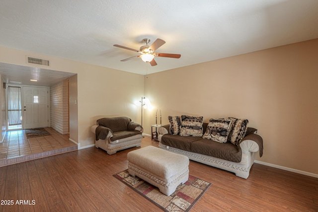 living room featuring hardwood / wood-style floors and ceiling fan