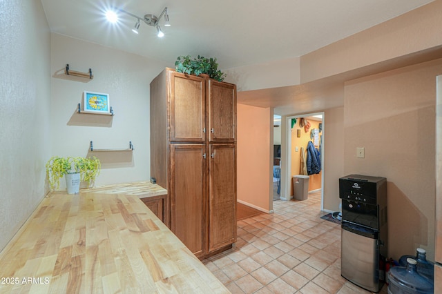 kitchen featuring butcher block countertops and light tile patterned flooring